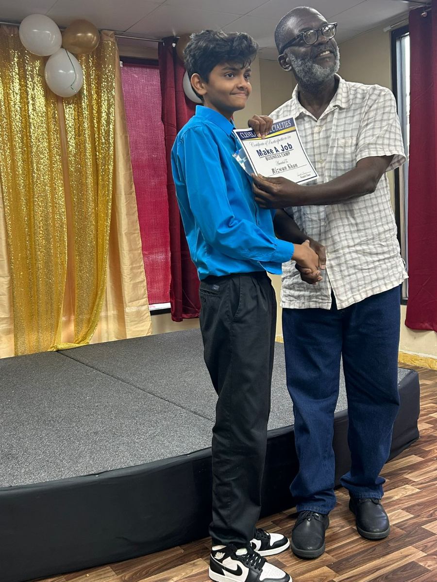 Camper receiving their Make a Job certificate from a mentor